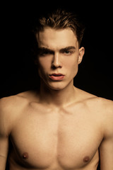 Muscle strong beautiful stripped male model portrait on black isolated font background