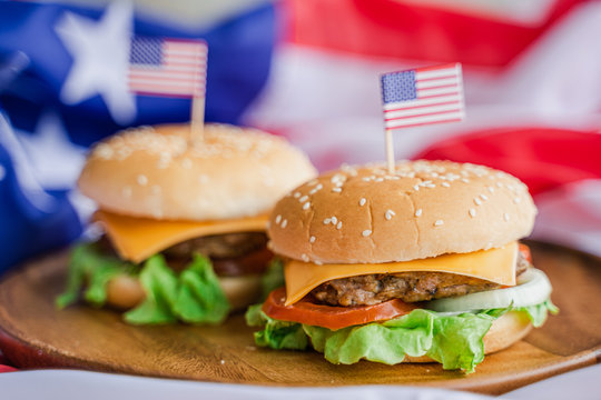 American hamburger or cheeseburger with america flag for USA 4th of July independence day food background concept