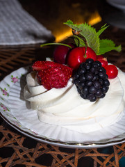 Pavlova cakes with cream and fresh summer berries