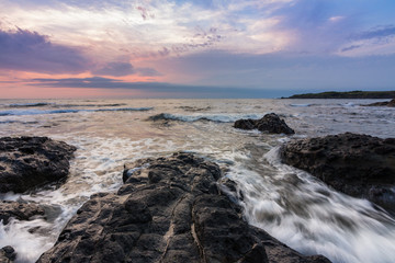 sunrise over the sea coast with rocks