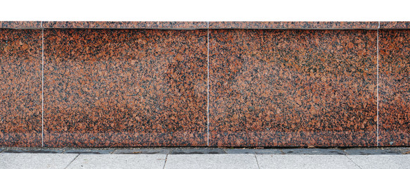 Wall from big red granite polished blocks are connected together by concrete