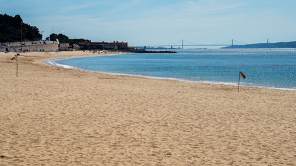 Giribita Beach near Lisbon, Portugal overlooking the iconic 25 April Bridge - Costa Verde Portuguese Riviera