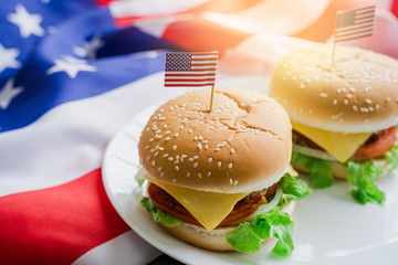 American hamburger or cheeseburger with america flag for USA 4th of July independence day food background concept