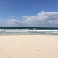 Fototapeta na wymiar Clear bright sand and surf at Gold Coast Australia
