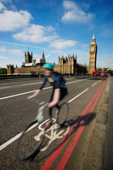 Fast moving London bicycle commuter crossing Westminster Bridge.