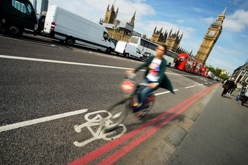 Fast moving London bicycle commuter crossing Westminster Bridge.