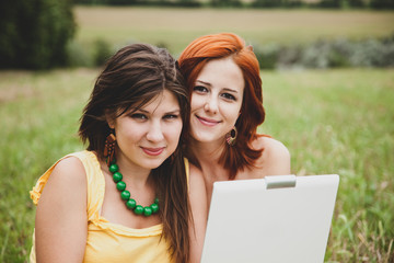 Two beautiful girls with notebook