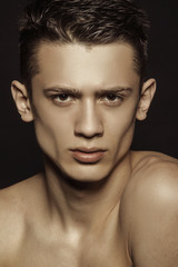 Fototapeta premium Muscle strong beautiful stripped male model portrait on black isolated font background