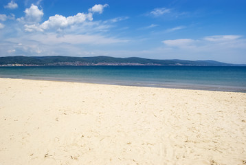 Fototapeta na wymiar Sea coast with a sandy beach and a panoramic view of the shoreline of the Bulgarian resort.