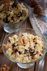 Salad of walnut, chicken and prunes in glass salad bowls, selective focus