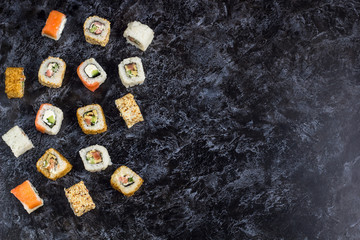 Set of sushi and maki on stone table. Top view with copy space