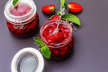 Strawberry jam in a glass jar.