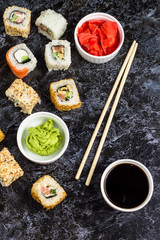 Set of sushi and maki on stone table. Top view