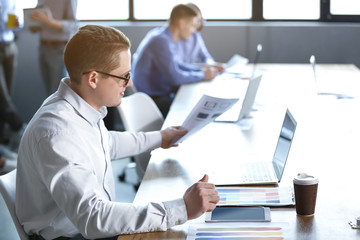 Young man during business meeting in office