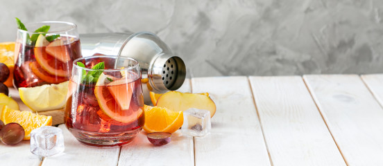Sangria and ingredients in glasses on wood background, copy space