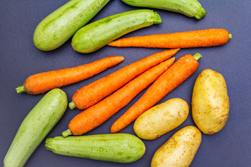 Fresh vegetables cooking black stone background