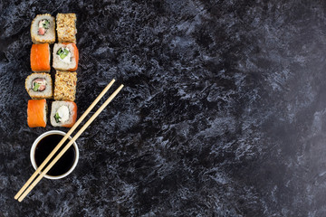 Plakat Set of sushi and maki on stone table. Top view with copy space