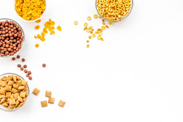 Various cereals in bowls on white background top view copyspace