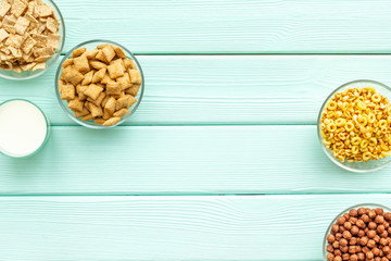 Cereals and flakes from corn and oat on mint wooden background top view mockup