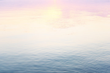 Obraz premium Calm water surface, blue and pink hue. Abstract background. Water texture