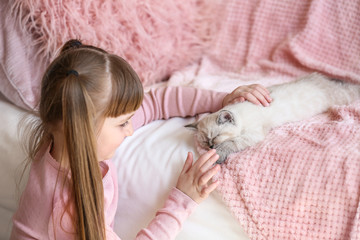Fototapeta na wymiar Girl with cute fluffy kitten at home