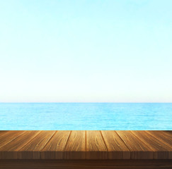 Wood table top on blur sea background. Summer, nature concepts. For montage product display or design key visual layout.