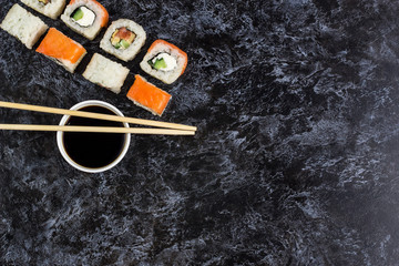 Set of sushi and maki on stone table. Top view with copy space