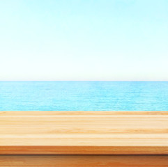 Fototapeta premium Table top with beach background, sky and cloud in sunny day for product display job showing. Wooden table for display or montage your products.