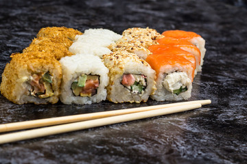 Set of sushi and maki on stone table. copy space