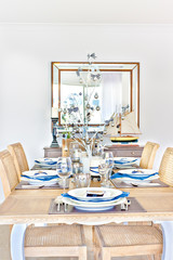 Dining table with ceramics also glasses.