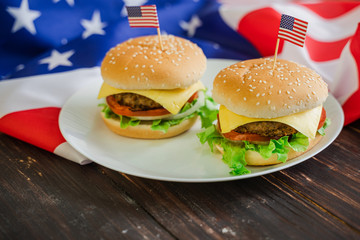 American hamburger or cheeseburger with america flag for USA 4th of July independence day food background concept