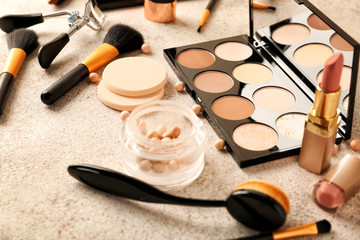 Obraz na płótnie Canvas Set of cosmetics for contouring makeup on grey background