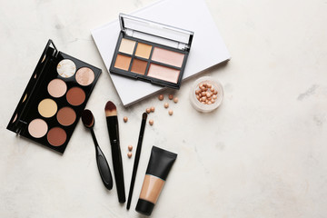 Set of cosmetics for contouring makeup on light background