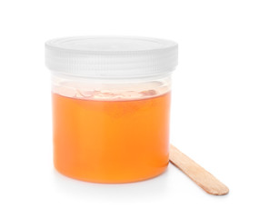 Container with sugaring paste for epilation on white background