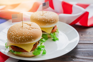 American hamburger or cheeseburger with america flag for USA 4th of July independence day food background concept