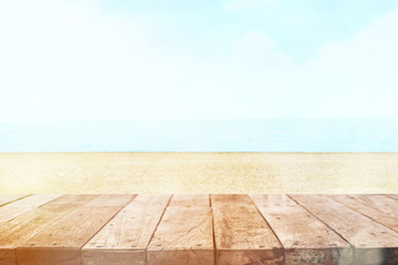 Table top with beach background, sky and cloud in sunny day for product display job showing. Wooden table for display or montage your products.