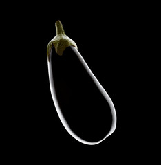 Single black aubergine, with strong rim light on black
