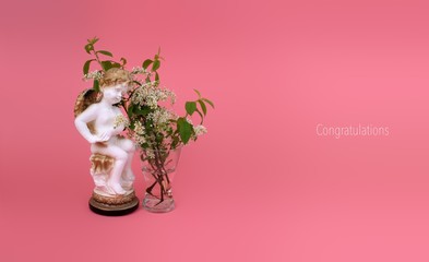 Composition with a blooming flower on a pink background