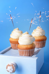 Tasty Birthday cupcakes on color background