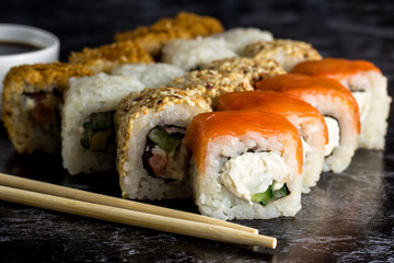 Set of sushi and maki on stone table. copy space