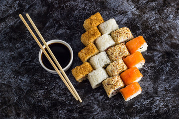 Set of sushi and maki on stone table. Top view with copy space