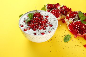 Bowl with tasty chia dessert on color background