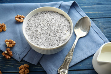 Bowl with tasty chia dessert on wooden table