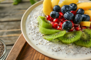 Bowl with tasty chia dessert on table, closeup