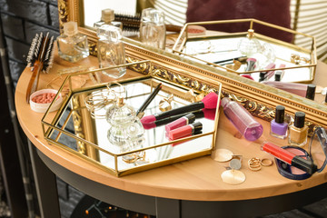 Table with cosmetics in modern makeup room