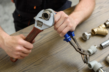 A worker is connecting elements of the plumbing.