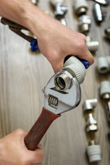 A worker is connecting elements of the plumbing.
