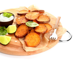 Board with tasty cooked sweet potato and sauce on white background