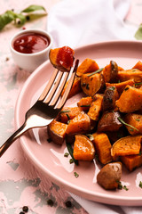 Plate with tasty cooked sweet potato on table