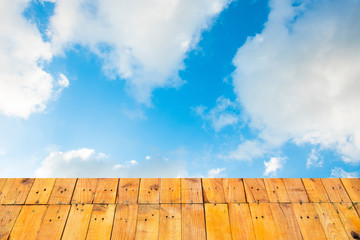  Old Wooden table  with blue sky white cloud background.